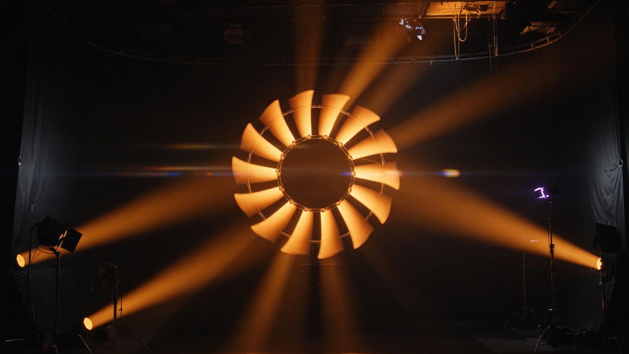 Spinning stage light throwing orange-gold rays in the dark